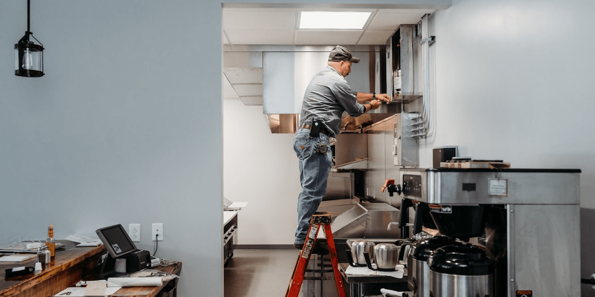 Swartz technician inspecting and testing the suppression system in a commercial kitchen